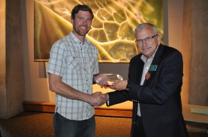 Rick Miller, co-owner, accepts the Organizational Partner Award from Dr. Jim Klett